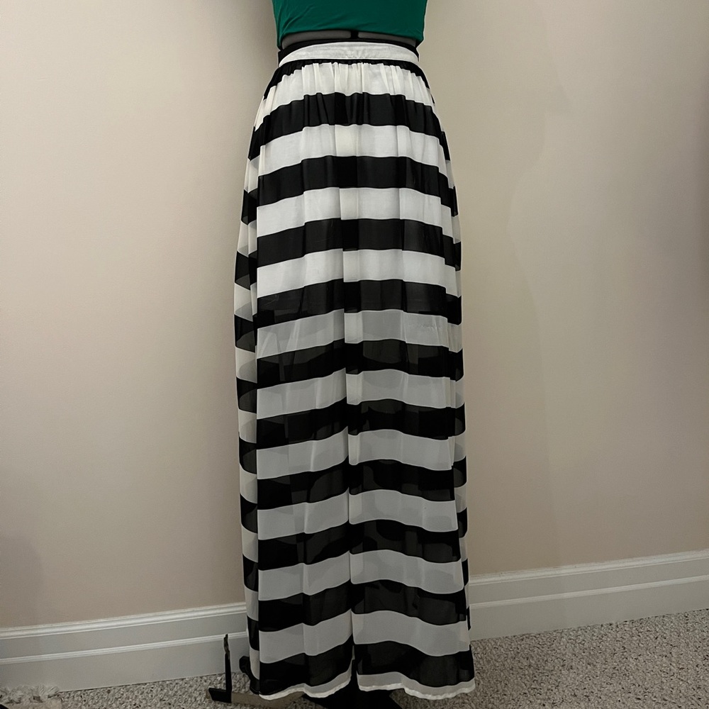 Sheer Volcom maxi skirt with black and white stripes. There is a white slip.
